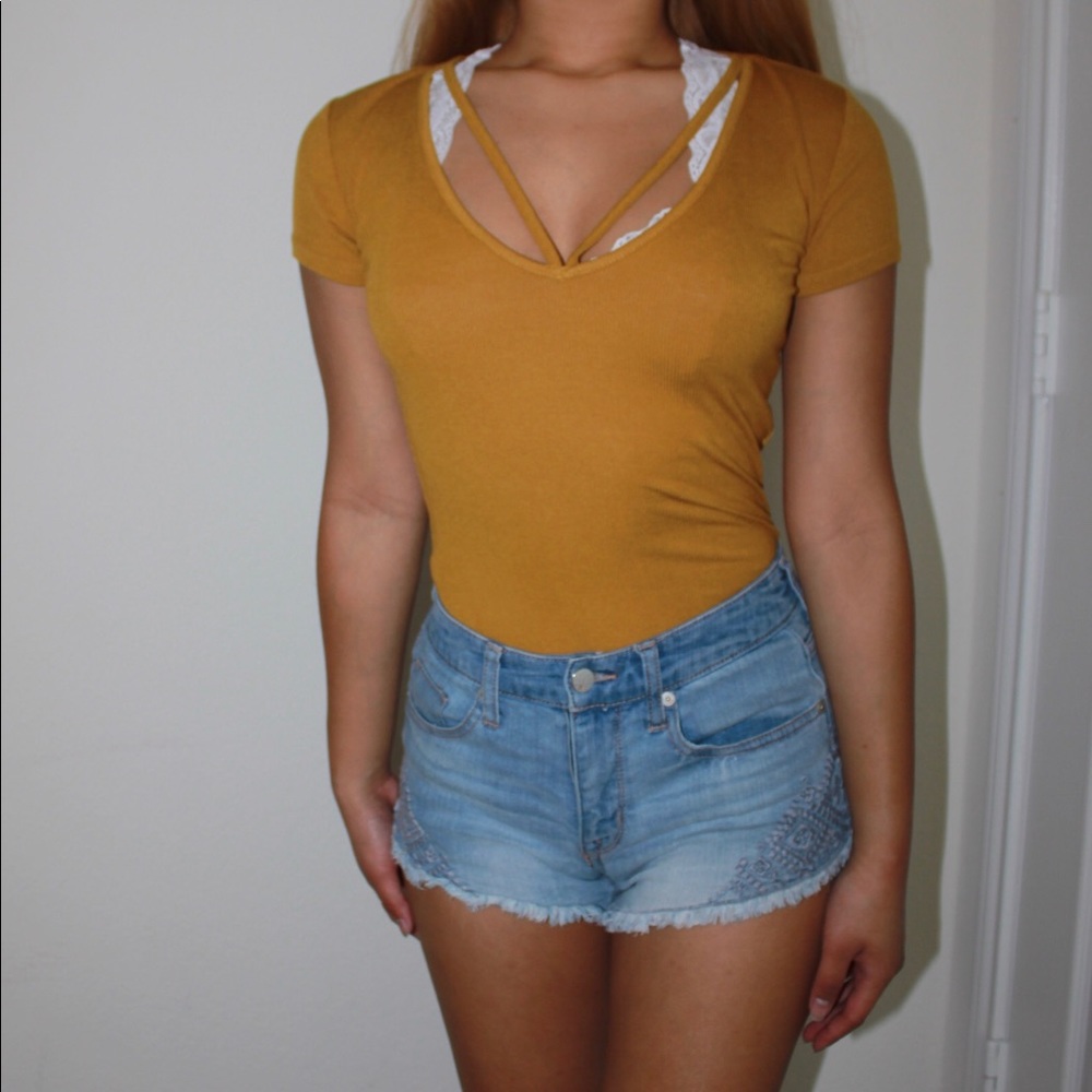 mustard yellow “v-neck” cut shirt